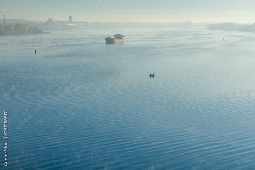 Cargo ship in fog on a river Dnieper