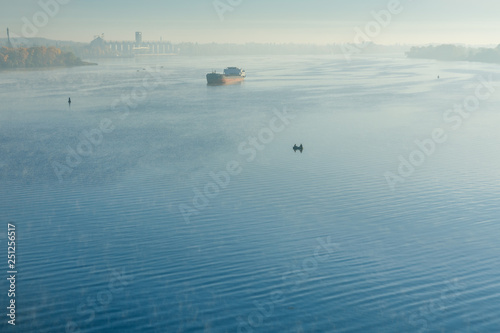 Fototapeta Naklejka Na Ścianę i Meble -  Cargo ship in fog on a river Dnieper