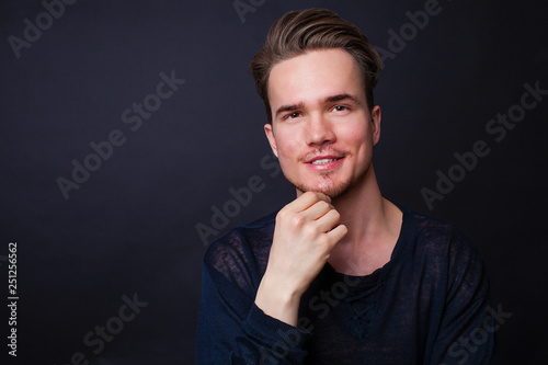 Studio portrait of young man on a dark background