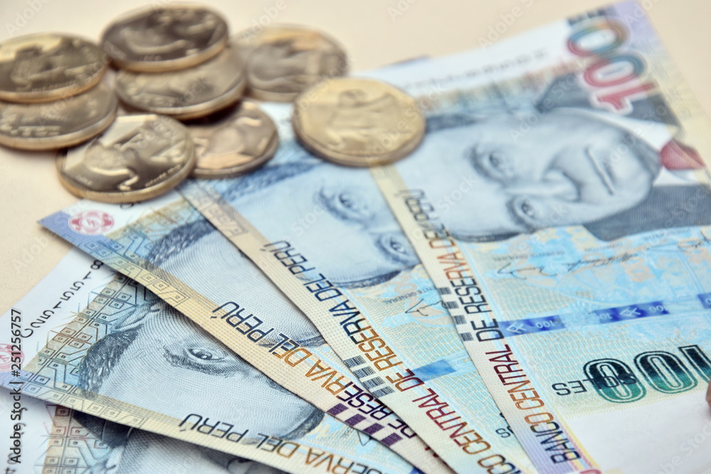 Peruvian banknotes with coins in the background Peruvian banknotes with coins in the background