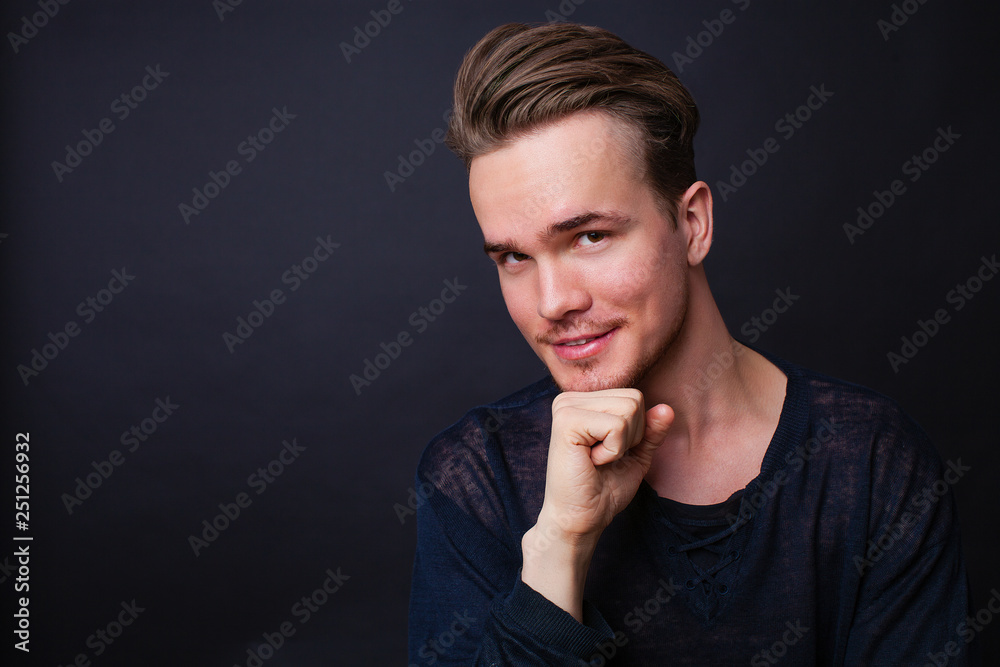 Studio portrait of a young man on a dark background Studio portrait of a young man on a dark background