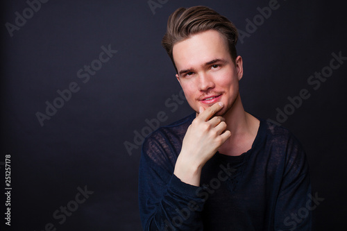 Studio portrait of young man on a dark background