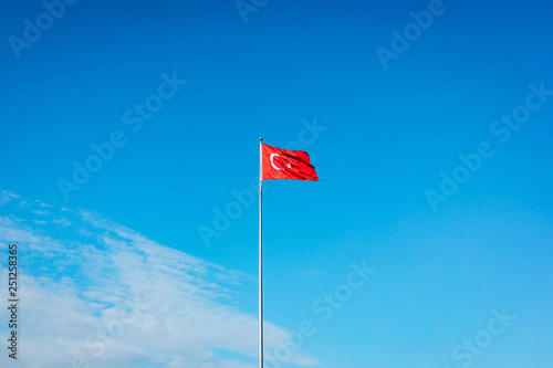 Turkish flag waving at blue sky. Turkey country flag flowing in the wind at blue sky. 