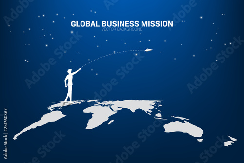 silhouette of businessman throw origami airplane on world map. Concept of world business market vision mission start up