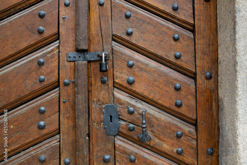 Aged wooden door with a handle, lock and keyhole