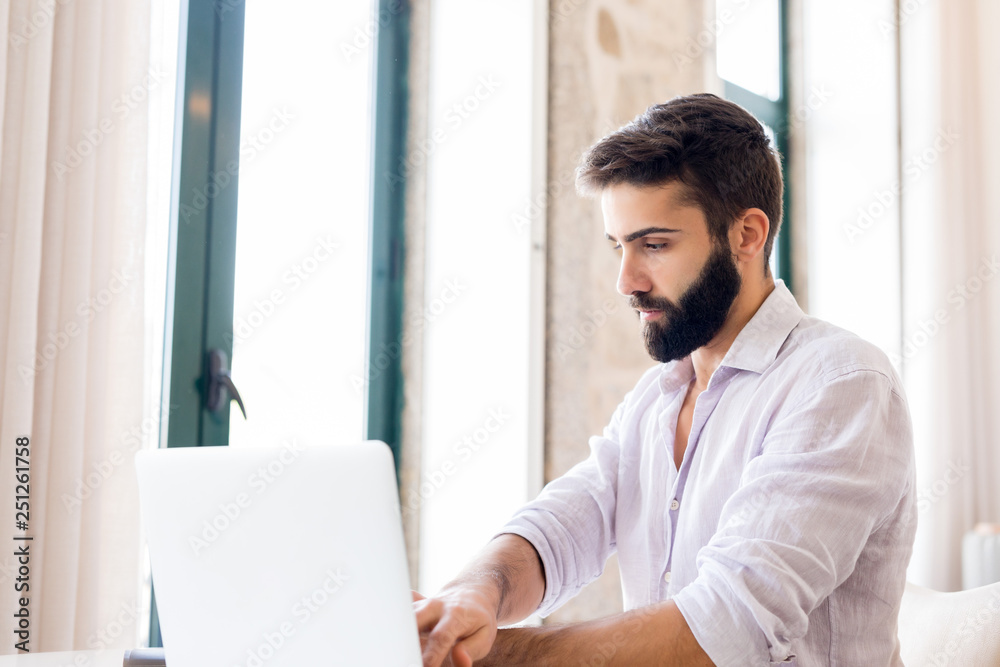 Man working on laptop from home