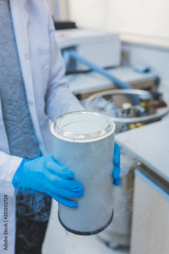 Researcher, scientist, physicist or laboratory assistant working, experimenting and analyzing in modern lab with liquid nitrogen Researcher, scientist, physicist or laboratory assistant working, experimenting and analyzing in modern lab with liquid nitrogen