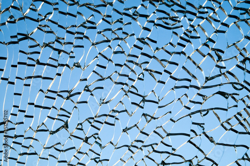 Background from cracked broken glass on a blue background.
