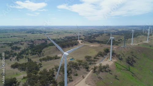 Static aerial view of turning wind turbines in Australia photo