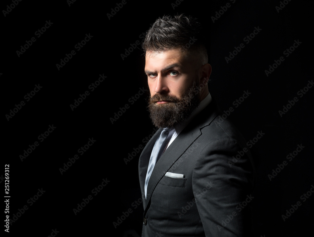 Rich man model. Business man concept. Businessman in dark grey suit with long beard. Man in classic suit, shirt and tie.