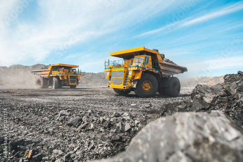 Large quarry dump truck. Loading the rock in dumper. Loading coal into body truck. Production useful minerals. Mining truck mining machinery, to transport coal from open-pit as the Coal Production photo