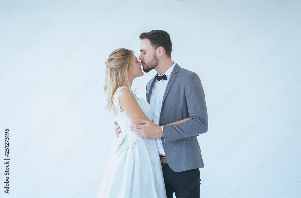 Portrait of groom with bride kissing and hugging together on white background,Happy and smiling in engagement day Portrait of groom with bride kissing and hugging together on white background,Happy and smiling in engagement day