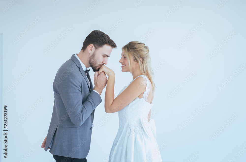 Happy and smiling in engagement day,Portrait of groom with bride kissing and hugging together on white background Happy and smiling in engagement day,Portrait of groom with bride kissing and hugging together on white background