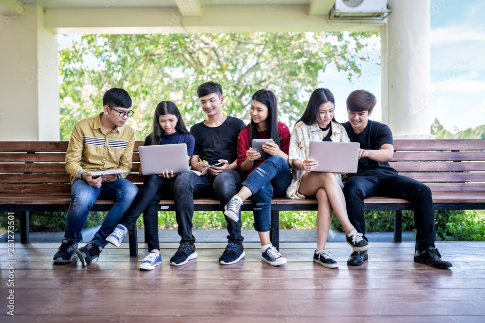 Fototapeta premium Group of asian young people studying in university sitting on chair