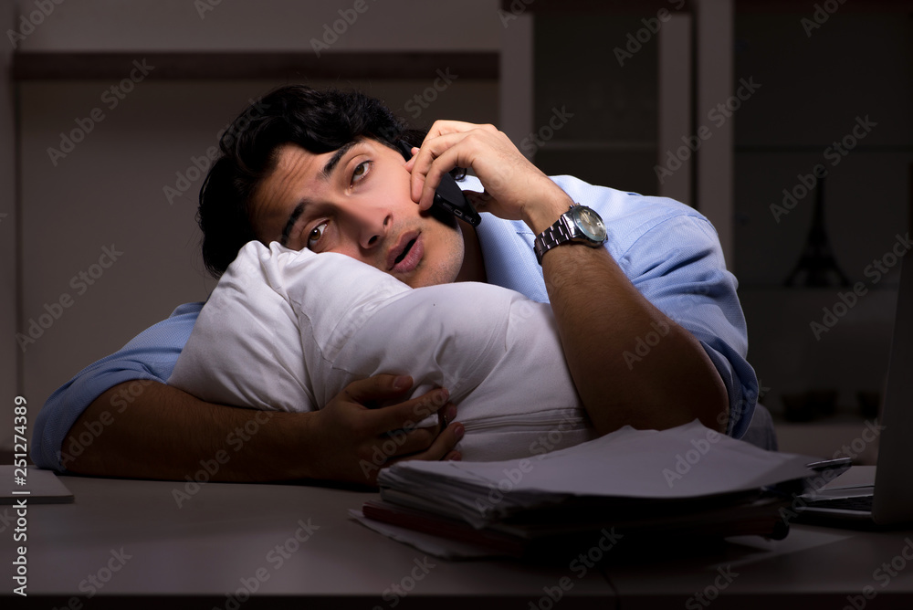 Young handsome employee and too much work in the office Young handsome employee and too much work in the office