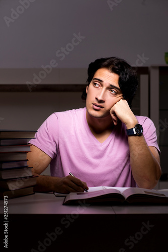 Male handsome student preparing for exams late at home  © Elnur