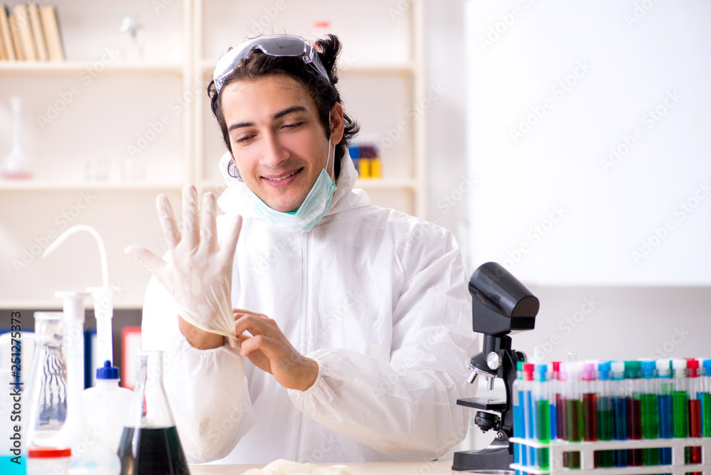 Young handsome chemist working in the lab Young handsome chemist working in the lab