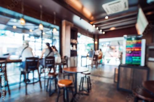 Blurred background image of coffee shop. abstract blur background with people in cafe. vintage color tone style