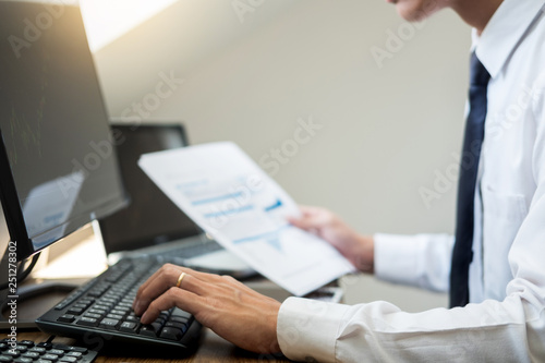 Financial broker  looking at the statistics of stock exchange and discussing on computer monitor, Business Investment Entrepreneur Trading Concept.