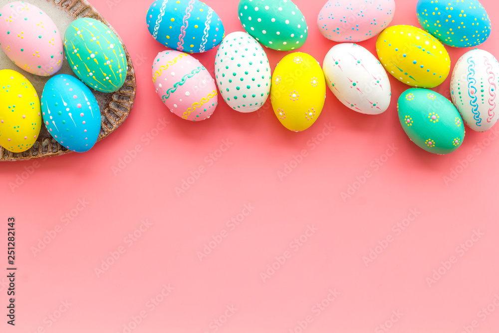 Easter composition. Decorated pastel Easter eggs on pink background top view space for text Easter composition. Decorated pastel Easter eggs on pink background top view space for text