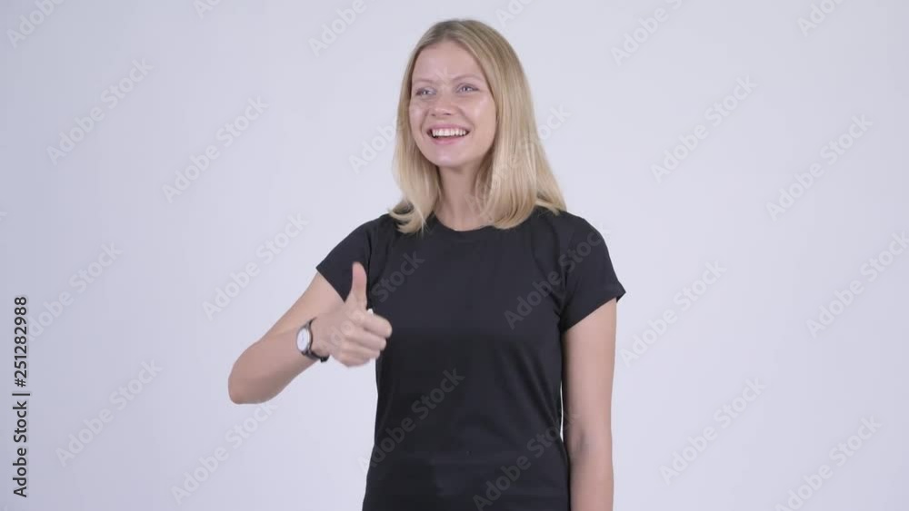 Young happy blonde woman giving thumbs up Young happy blonde woman giving thumbs up