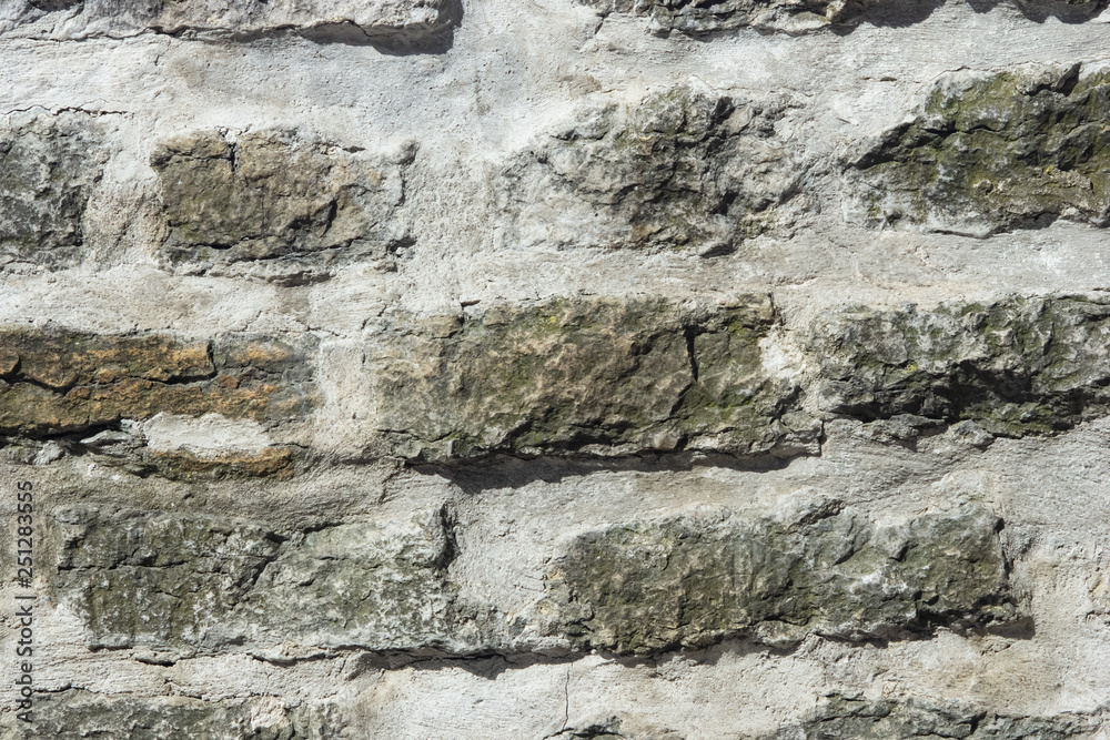 Old grey rough stone wall close-up texture background, selective focus, shallow DOF Old grey rough stone wall close-up texture background, selective focus, shallow DOF
