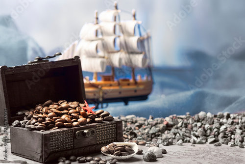 Image of middle-aged coffee beans. Poured into a pirate chest. Precious, expensive, tonic, invigorating, fragrant, delicious, high-quality, roasted drink. Brown, glossy grains.