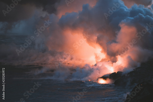 Big Island of Hawaii Volcano Lava and Magma spew into the pacific ocean with plumes of smoke and ash USA
