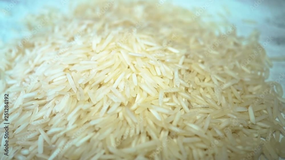 Slow rotating white rice on cloth placemat Slow rotating white rice on cloth placemat