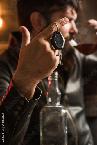 Macho drinking. Confident man with car keys in his hand. Do not drink and drive Cropped image of drunk man talking car keys.