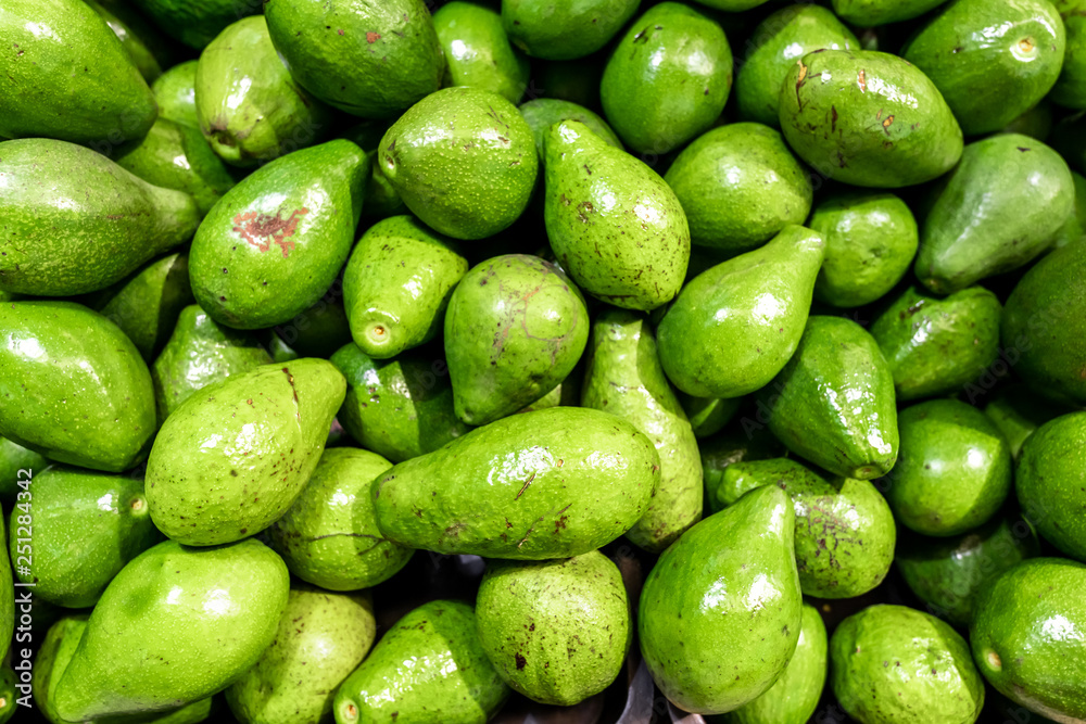 Fresh organic exotic green avocado on a local food market, Bali island. Avocado background. Fresh organic exotic green avocado on a local food market, Bali island. Avocado background.