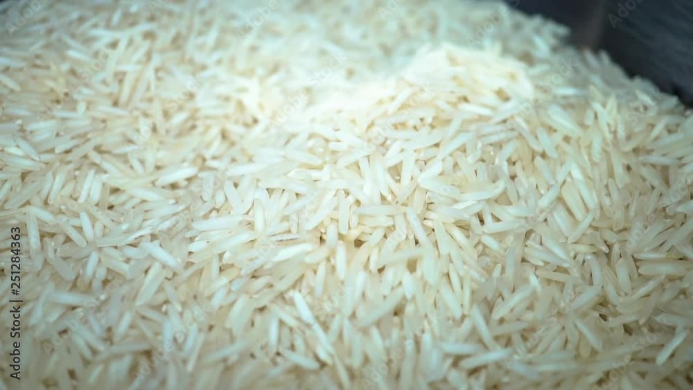 Slow motion white rice falling into metal bowl Slow motion white rice falling into metal bowl