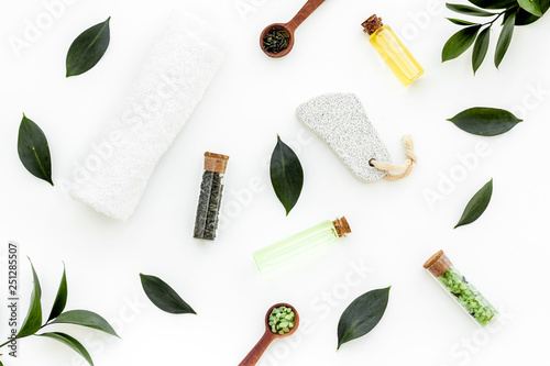 Spa composition with essential tea tree oil. Fresh tea tree leaves, natural cosmetics, towel on white background top view