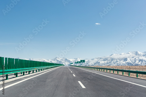 highway with snow mountains