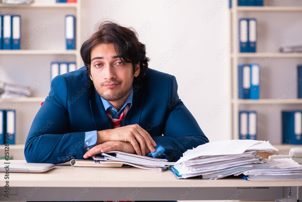 Young handsome businessman sitting in the office Young handsome businessman sitting in the office