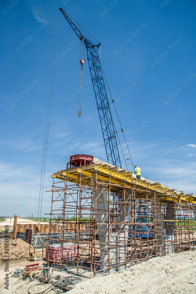Hoisting crane at bridge support construction