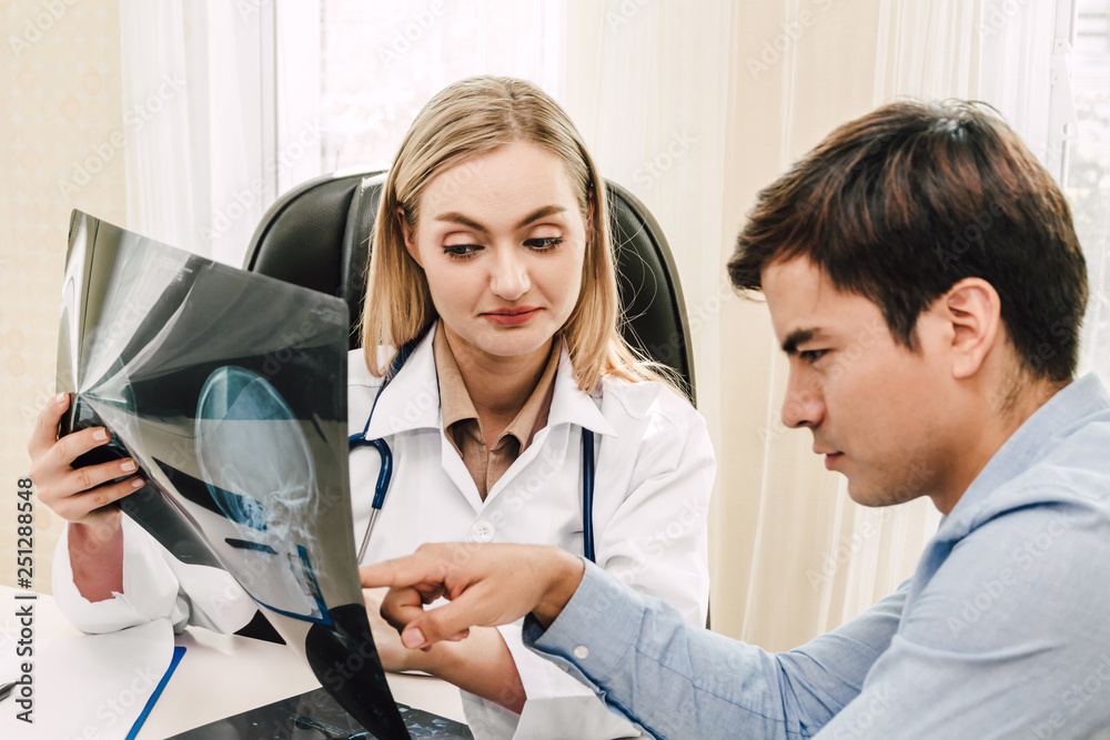 Fototapeta premium Female doctor looking at x-ray photo in hospital.healthcare and medicine