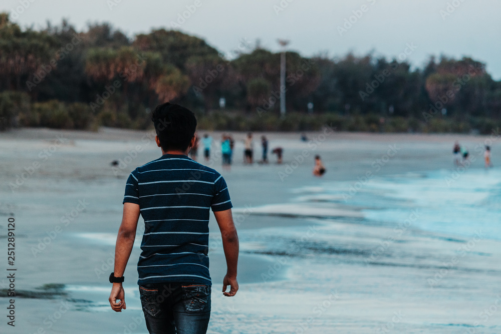 Man taking a walk on the beach