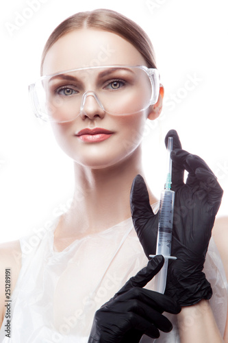 Attractive woman doctor with syringe, black rubber protective gloves. Health care concept