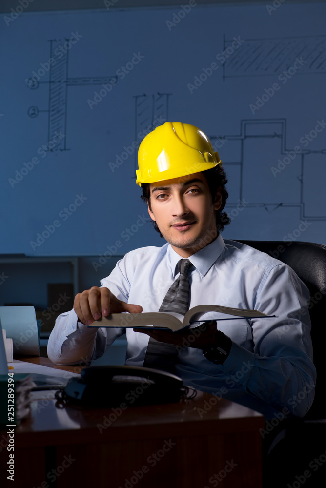 Young construction architect working on project at night Young construction architect working on project at night