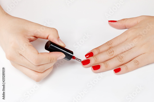paint one s nails with a brush. Menicure.