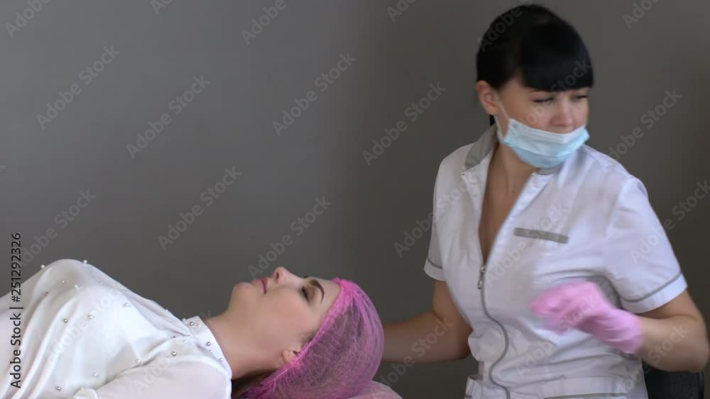 doctor cosmetologist makes Rejuvenating facial injections procedure for tightening and smoothing wrinkles on face skin of beautiful, young woman in beauty salon. Cosmetology skin care