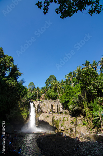 Tegenungan waterfall with blue skies above Kemenuh Village, Sukawati, Gianyar, Bali, Indonesia
