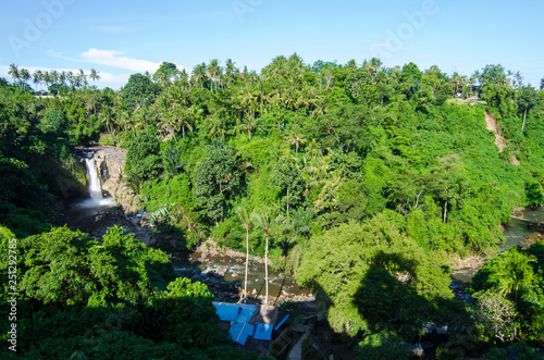Tegenungan waterfall from hill with blue skies above Kemenuh Village, Sukawati, Gianyar, Bali, Indonesia