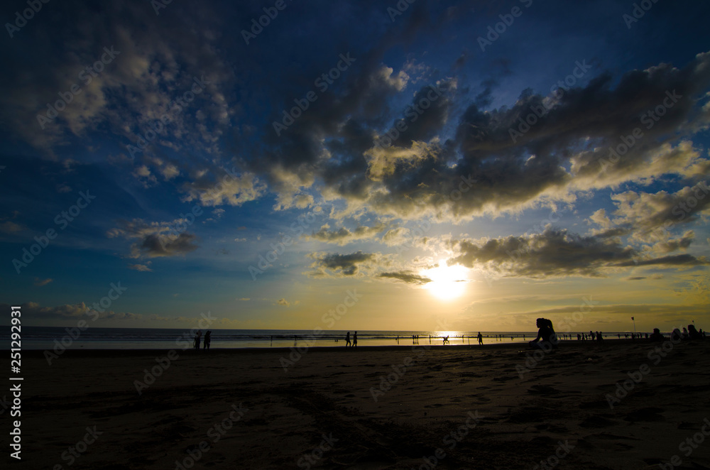 A couple enjoy their sunset at Double Six Beach, Legian, Seminyak, Kuta, Bali, Indonesia