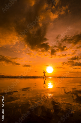 Jogging while sunset at Double Six Beach, Legian, Seminyak, Kuta, Badung, Bali, Indonesia