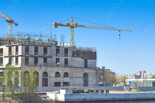 Construction of a dwelling house, cranes, working builders