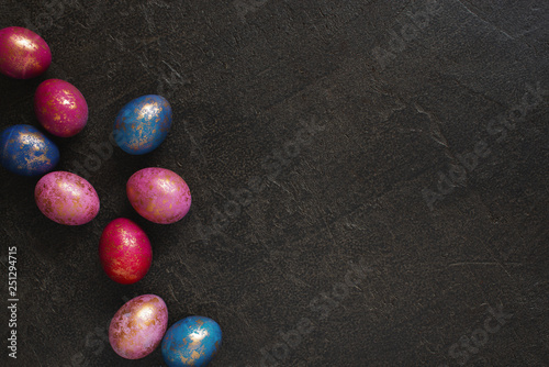 Background with painted colorful Easter eggs with golden spots