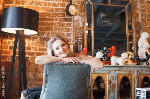 fashion details of elegant beautiful woman sitting barefoot in vintage cafe in black velvet dress, rich stylish lady, elegant trend, took off her shoes, golden high heeles sandals, footwear photo