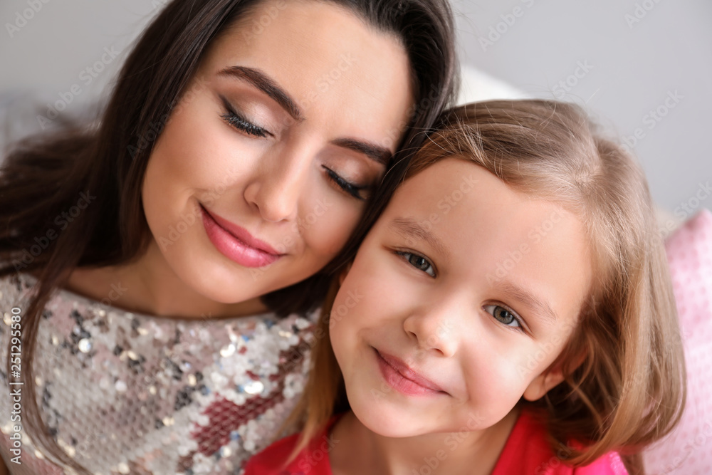 Portrait of cute little girl with mother